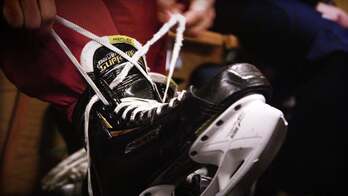 A hockey skate being tied