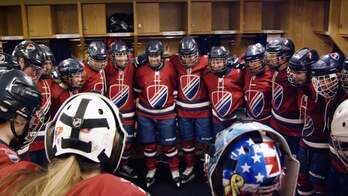 A hockey team gathered in a locker room