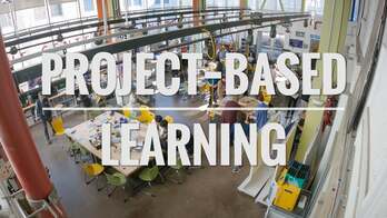 A title card in front of a library