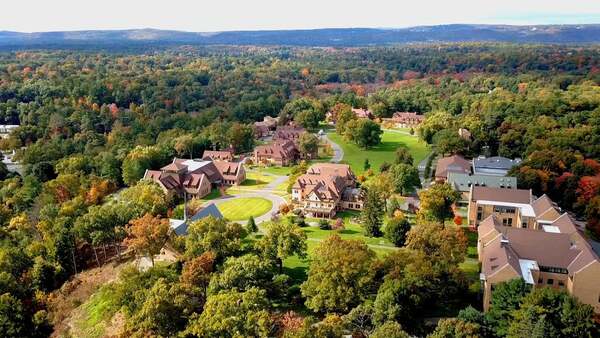 Drone shot of a school amid fall foliage