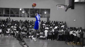 A basketball player rising for a dunk