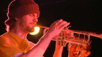A man playing a trumpet on stage